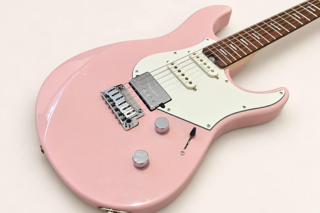 An Idiot's Guide to Not Losing Money on Guitars 1 Dana's ash-pink Yamaha Pacifica Standard Plus, photographed diagonally against a plain cream background