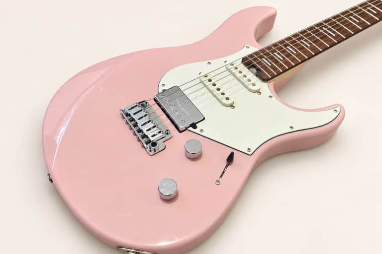 Dana's ash-pink Yamaha Pacifica Standard Plus, photographed diagonally against a plain cream background