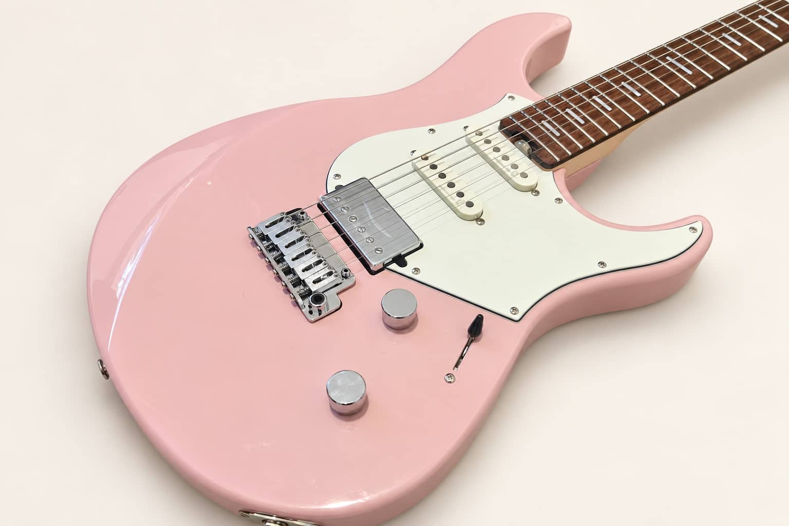 Dana's ash-pink Yamaha Pacifica Standard Plus, photographed diagonally against a plain cream background